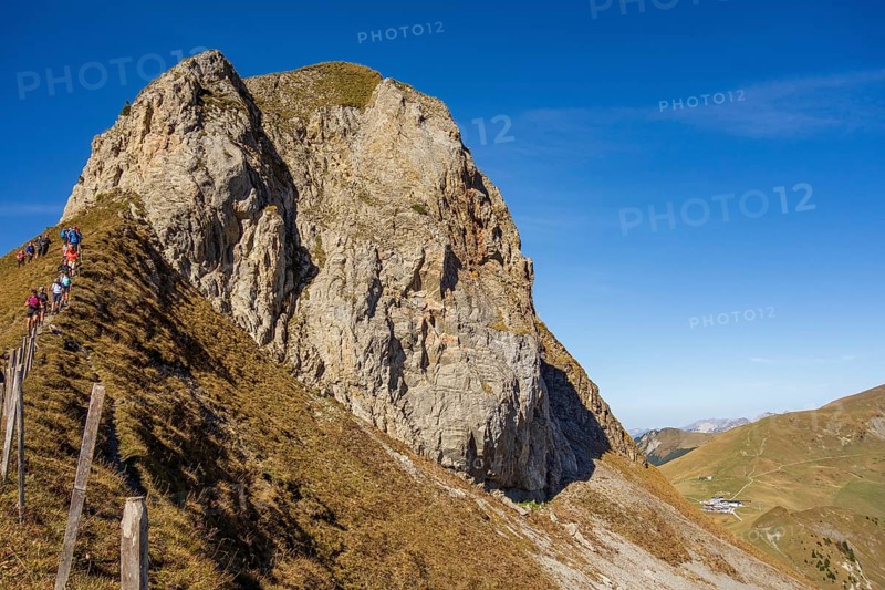 Steep cliff with hikers along a path under a clear sky, saas Fee, Alps, Switzerland, Europe