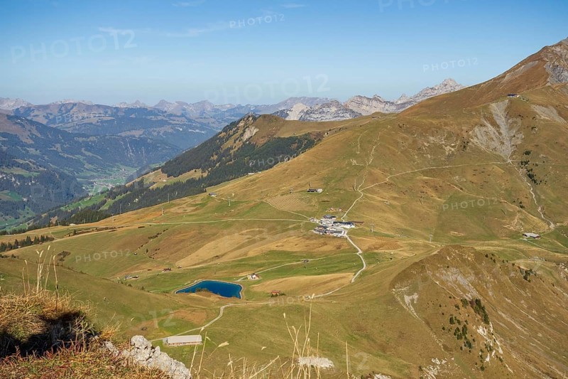 View of a wide valley with a small lake in the middle of a mountainous landscape, saas Fee, Alps, Switzerland, Europe