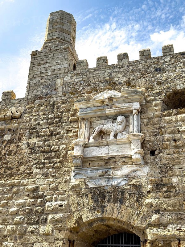 View of seaward outer wall with tower and battlements seen from harbour entrance of fortress built in the Middle Ages 16th century by Republic of Venice old name Castello Rocca al Mare today Koules, in centre of picture symbol of power Venetian lion in harbour of Iraklion on north coast of island Crete Aegean Aegean Cretan Sea Mediterranean, Heraklion, Crete, Greece, Europe
