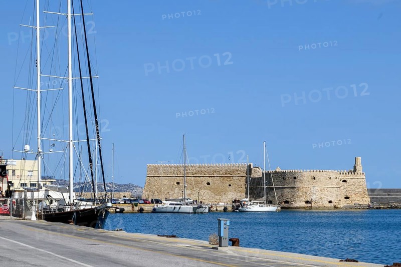 View from modern quay wall on fortress built in the Middle Ages 16th century by the Republic of Venice old name Castello Rocca al Mare today Koules in the harbour of Iraklion, on the left at the edge of the picture sailor two-master, Heraklion, Crete, Greece, Europe