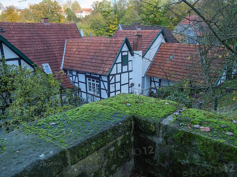 Village view with half-timbered houses, red roofs and moss-covered stones in autumn, Tecklenburg, Germany, Europe