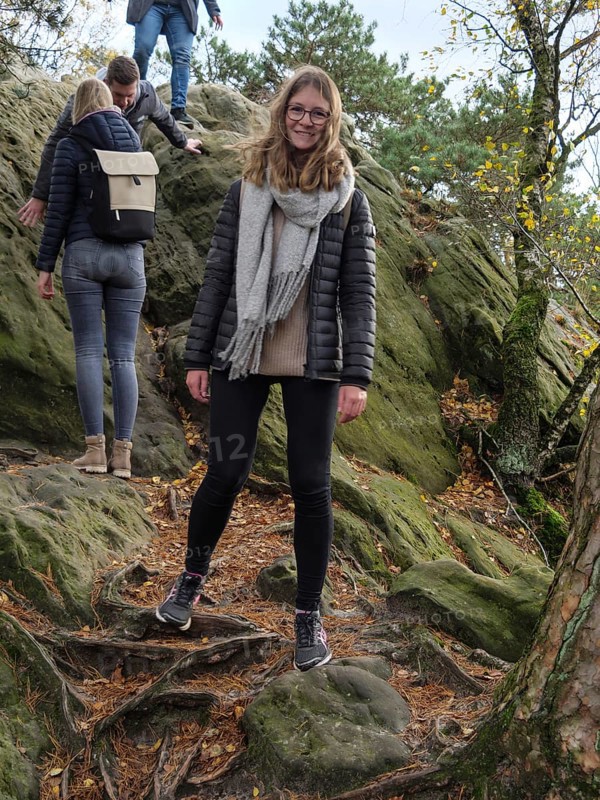 A woman enjoying autumn hiking over rocky terrain with friends, Tecklenburg, North Rhine-Westphalia, Germany, Europe