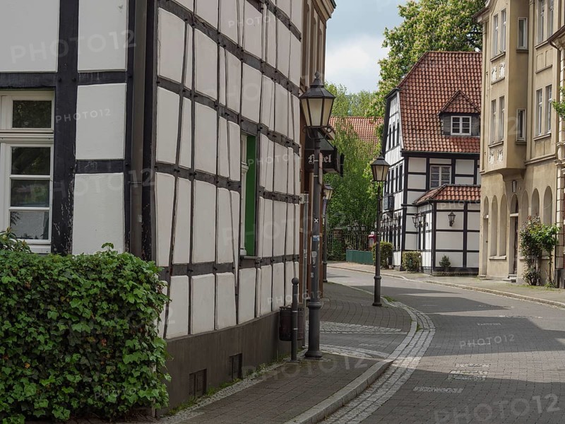 Historic half-timbered houses on a quiet, cobbled street with street lamps and green shutters, Westerholt, Herten Ruhr Area, North Rhine-Westphalia, Germany, Europe
