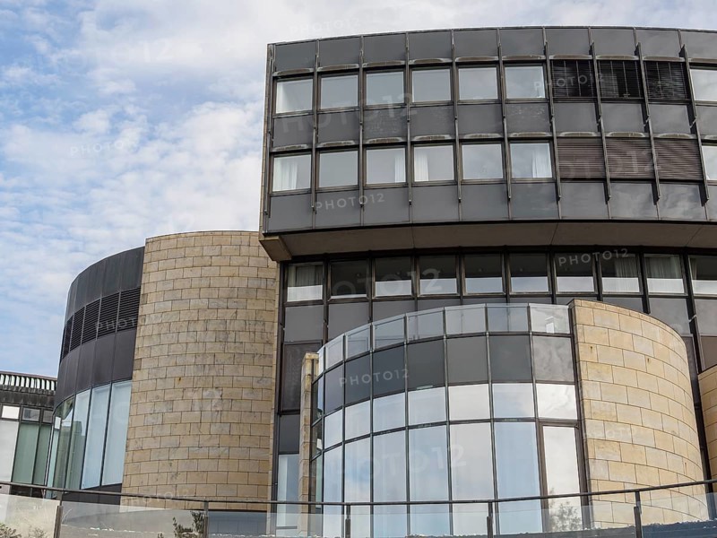 Modern building with glass facades and round design under a slightly cloudy sky, Düsseldorf, North Rhine-Westphalia, GERMANY