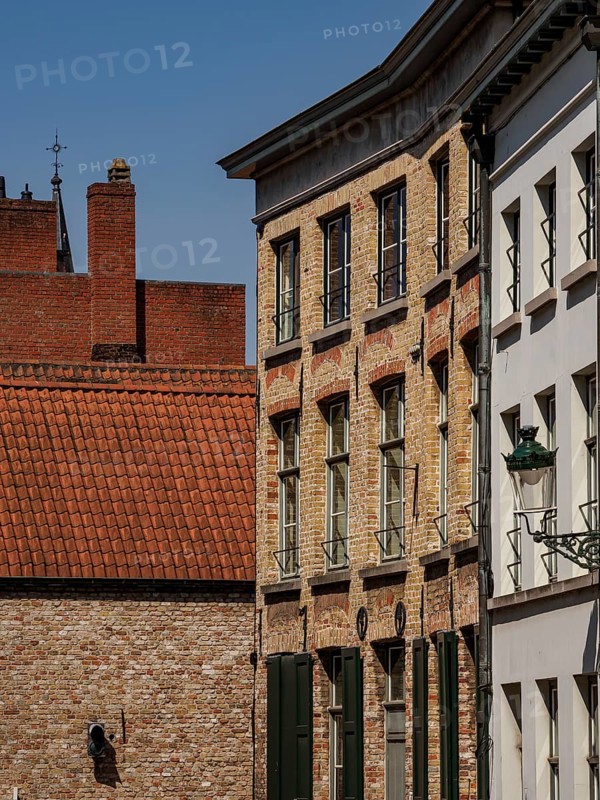 Rows of brick houses and plastered facades under a clear sky, de haan, Belgium, Europe