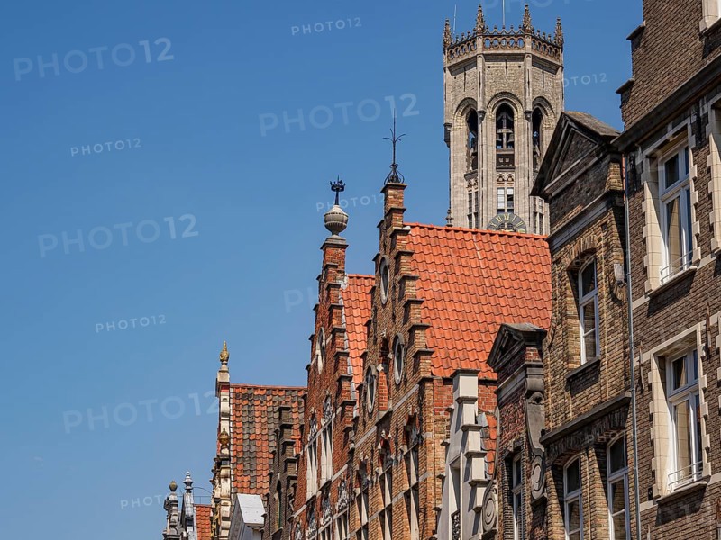 Historic cityscape with striking towers and brick buildings on a sunny day, Bruges, Belgium, Europe
