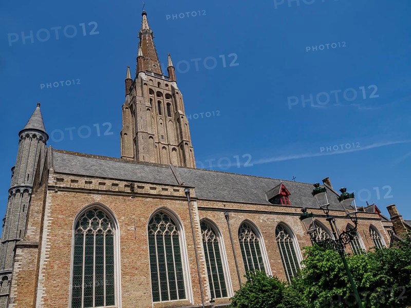 Large Gothic church with towers and large windows in Bruges on a sunny day, Bruges, Belgium, Europe