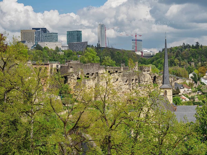 Ruins of a castle in front of a modern skyline with skyscrapers and green spaces, Luxembourg City, Luxembourg, Europe