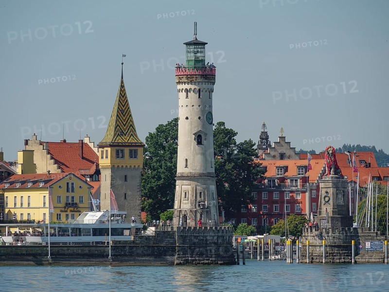 Lighthouse and historic buildings on the lakeshore in a town, Lindau, Lake Constance, Germany, Europe