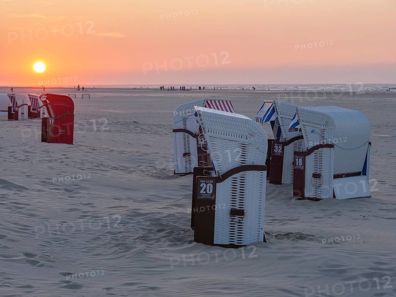 Several beach chairs stand on the quiet beach during sunset, dusk bathes the scene in soft light, juist, ostfriesland, Germany, Europe