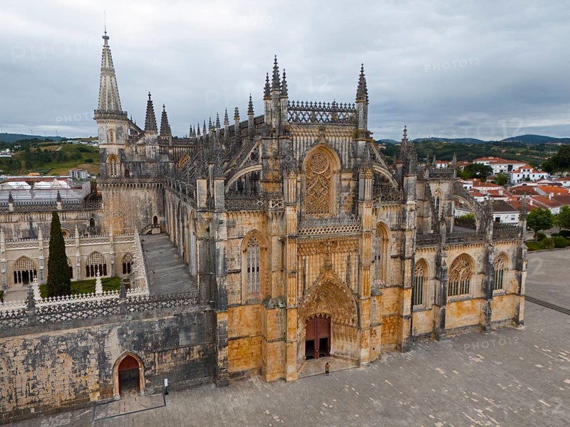 Impressive Gothic cathedral with a grand entrance and detailed towers under a cloudy sky, aerial view, monastery, Mosteiro de Santa Maria da Vitoria, 'unfinished chapels', UNESCO World Heritage Site, Batalha, Leiria, Estremadura, Portugal, Europe