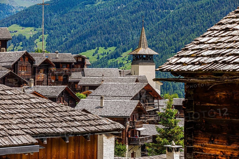 Old wooden houses with wooden shingle roofs in the historic centre of Grimentz, behind the church of Saint Theodule, Val d'Anniviers, Valais Alps, Canton Valais, Switzerland, Europe