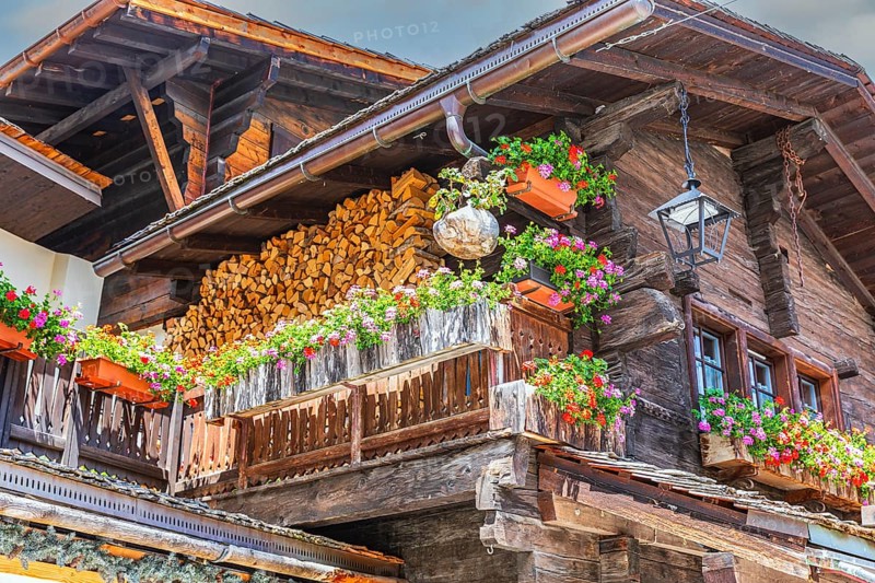 Nested old wooden house with lantern on the roof and flower boxes in front of windows and balconies, historic village centre, Grimentz, Val d'Anniviers, Valais Alps, Canton Valais, Switzerland, Europe