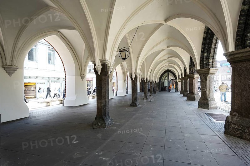 Arcades under the townhall of Luebeck, Germany, historic architecture at the market place in the old town in the city center, copy space, selected focus, Europe