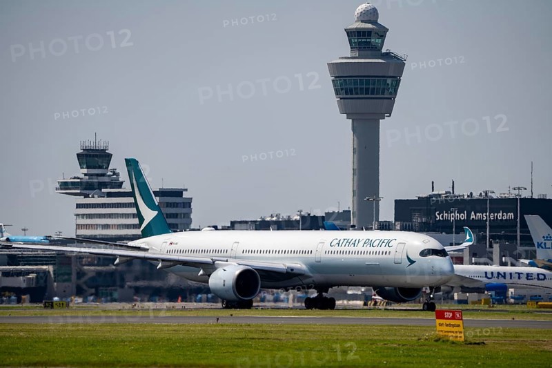 Cathay Pacific aircraft at Amsterdam Schiphol Airport, on the taxiway for take-off on the Aalsmeerbaan, 18L/36R, air traffic control tower, terminal, Netherlands