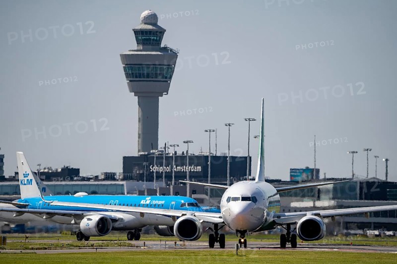 Aircraft at Amsterdam Schiphol Airport, on the taxiway for take-off on the Aalsmeerbaan, 18L/36R, air traffic control tower, terminal, Netherlands