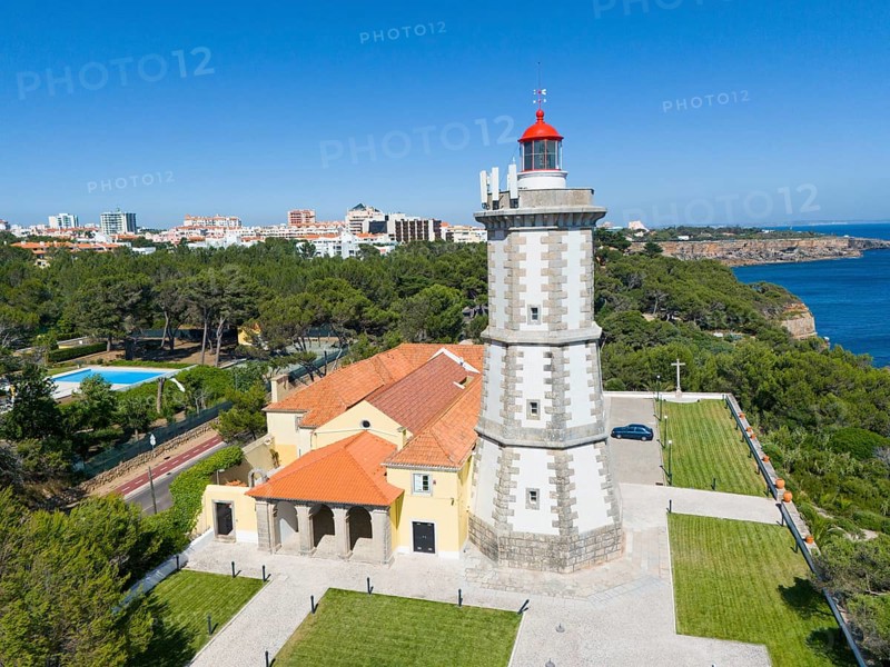 A lighthouse with a red top next to a building with a view of the forest and the sea, aerial view, Farol da Guia, Cabo da Guia, Cascais, Lisbon, Lisboa, Portugal, Europe