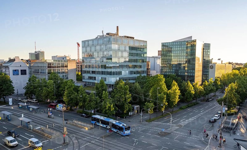 View from above of the crossroads at Stiglmaierplatz with public bus, modern office buildings in the evening light, Löwenbräu brewery building, Stiglmaierplatz, Munich, Upper Bavaria, Bavaria, Germany, Europe