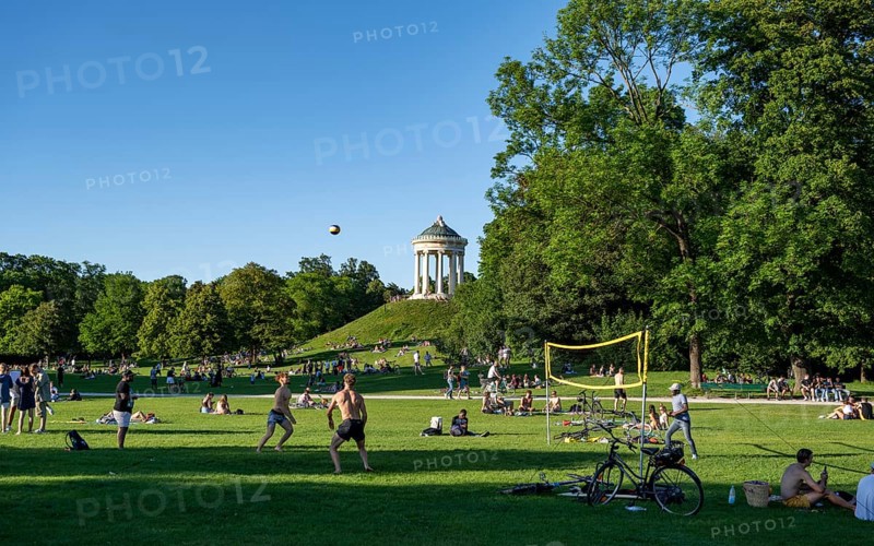People playing volleyball in a meadow in the English Garden, people enjoying the summer day in the park, Monopteros in the background, Munich, Upper Bavaria, Bavaria, Germany, Europe