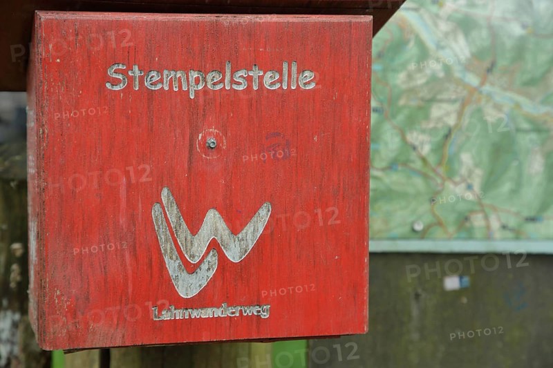 Red stamping point with hiking sign on the Lahnwanderweg trail at the source of the Lahn with symbol, sign, hiking trail, wooden box, Lahn, source of the Lahn, Lahnhof, Netphen, Rothaargebirge, Siegerland, North Rhine-Westphalia, Germany, Europe