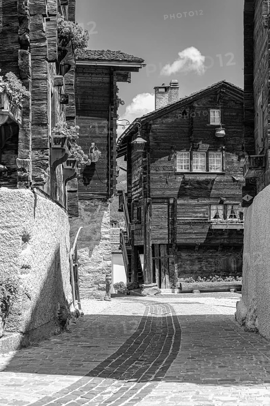 Paved footpath surrounded by old wooden houses, historic village centre, black and white photograph, Grimentz, Val d'Anniviers, Valais Alps, Canton Valais, Switzerland, Europe