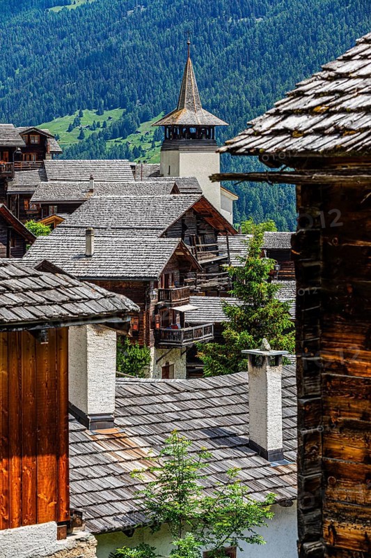 Old wooden houses with wooden shingle roofs in the historic centre of Grimentz, behind the church of Saint Theodule, Val d'Anniviers, Valais Alps, Canton Valais, Switzerland, Europe