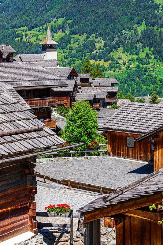 Old wooden houses with wooden shingle roofs in the historic centre of Grimentz, behind the church of Saint Theodule, Val d'Anniviers, Valais Alps, Canton Valais, Switzerland, Europe
