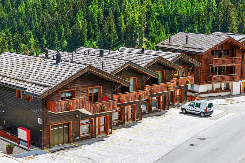 Parked car in front of wooden terraced houses, historic village centre, Grimentz, Val d'Anniviers, Valais Alps, Canton Valais, Switzerland, Europe