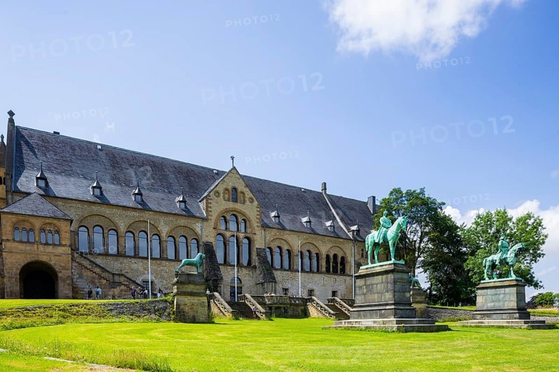 The imperial palace of Goslar covers an area of around 340 by 180 metres, situated at the foot of the Rammelsberg in the south of the town of Goslar, on which the imperial house, the former collegiate monastery St. Simon and Judas, the palace chapel of St. Ulrich and the Church of Our Lady are or were located. The imperial palace, built between 1040 and 1050 under Henry III, is a unique monument to secular architecture. For over 200 years, German and European history was written here at numerous imperial and court conventions. Copies of the Brunswick Lion and equestrian monuments in front of the imperial palace, Kaiserpfalz Goslar, Goslar, Lower Saxony, Germany, Europe