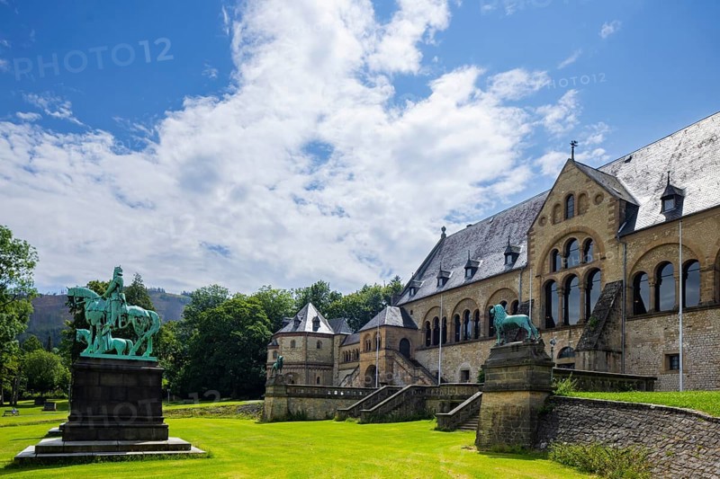 The imperial palace of Goslar covers an area of around 340 by 180 metres, situated at the foot of the Rammelsberg in the south of the town of Goslar, on which the imperial house, the former collegiate monastery St. Simon and Judas, the palace chapel of St. Ulrich and the Church of Our Lady are or were located. The imperial palace, built between 1040 and 1050 under Henry III, is a unique monument to secular architecture. For over 200 years, German and European history was written here at numerous imperial and court conventions. Copies of the Brunswick Lion and equestrian monuments in front of the imperial palace, Kaiserpfalz Goslar, Goslar, Lower Saxony, Germany, Europe