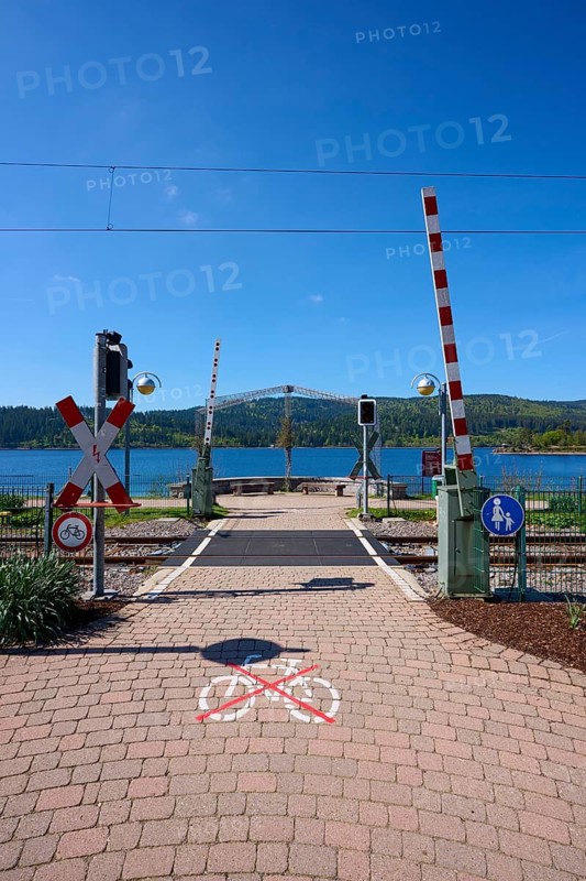Railway crossing at Schluchsee and blue sky, embedded in a mountain landscape, Schluchsee, Black Forest, Baden-Württemberg, Germany, Europe