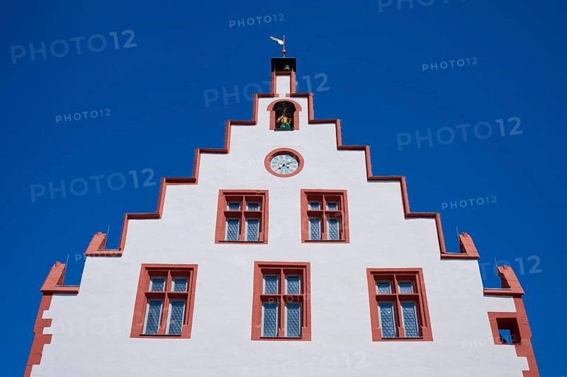 Karlstadt Town Hall, Historic building facade with red details and a clock under a clear blue sky, Karlstadt, Main Spessart, Bavaria, Germany, Europe