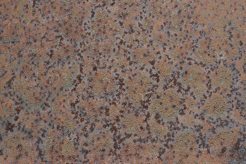 Grunge background of blistered paint on rusty metal