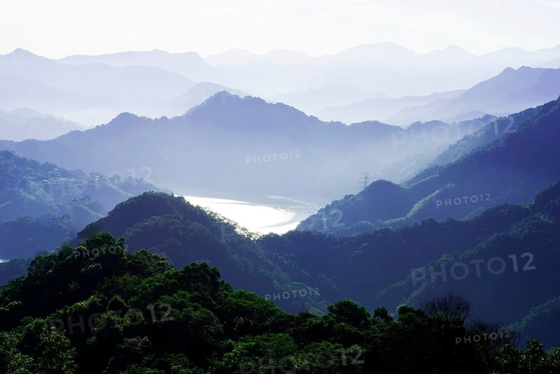 A misty mountain range with layered hills and valleys bathed in tranquil morning light, Shimen Reservoir, Taoyuan, Taiwan, Asia