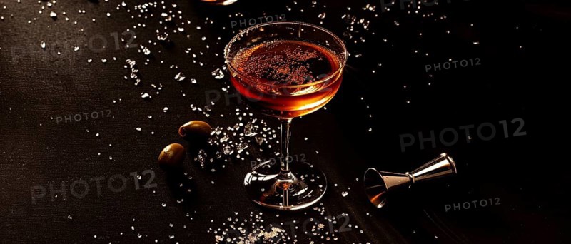 Sophisticated dark cocktail in a glass with a sugar rim, set in dim light creating elegant moody vibes, AI generated