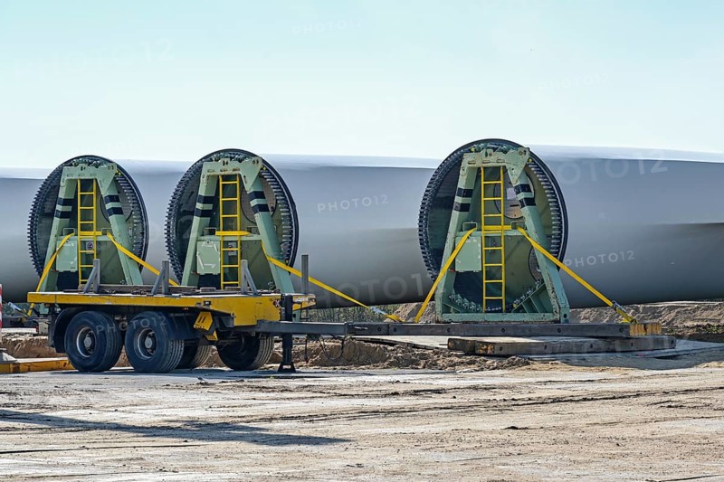 Wind turbine blades are stored near the construction site, heavy industry in preparation for a renewable energy power plant, copy space, selected focus