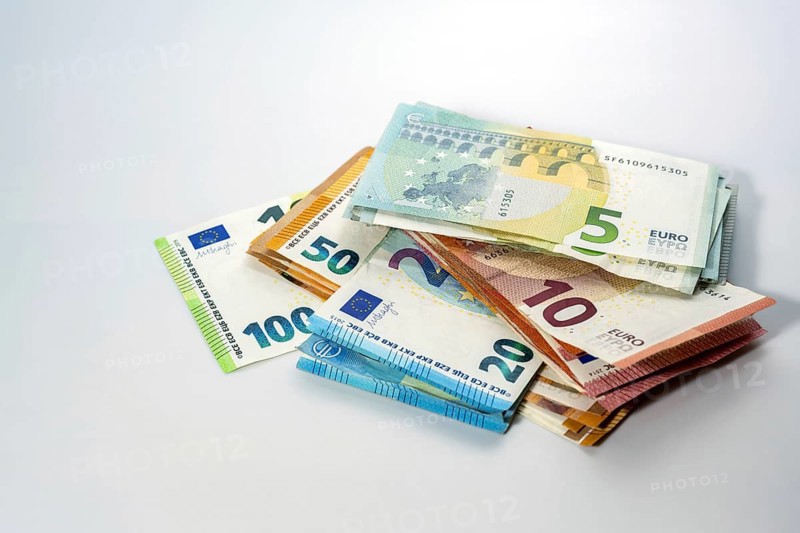 Stack of different euro banknotes on a light gray background, concept for business, finance, inflation and economy, copy space, selected focus, narrow depth of field