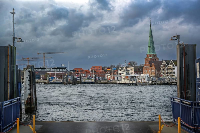 Lubeck Travemunde, Germany, January 15, 2023: Landing stage of the ferry across the river Trave from Priwall to the old town of Travemunde on the Baltic Sea under a dark cloudy sky, copy space, Europe