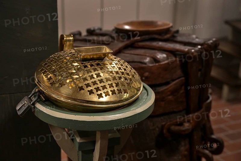 Offertory box made of brass with an iron lock in a Christian church, used to collect money for charitable or religious purposes after the worship, copy space, selected focus, narrow depth of field