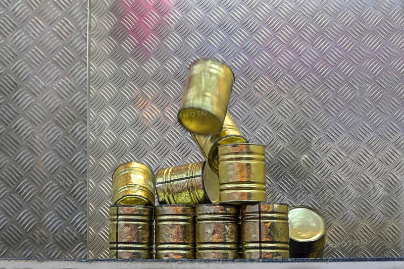 Falling tin can pyramid hit by a ball, throwing game at a carnival funfair or Christmas market, copy space, selected focus, motion blur