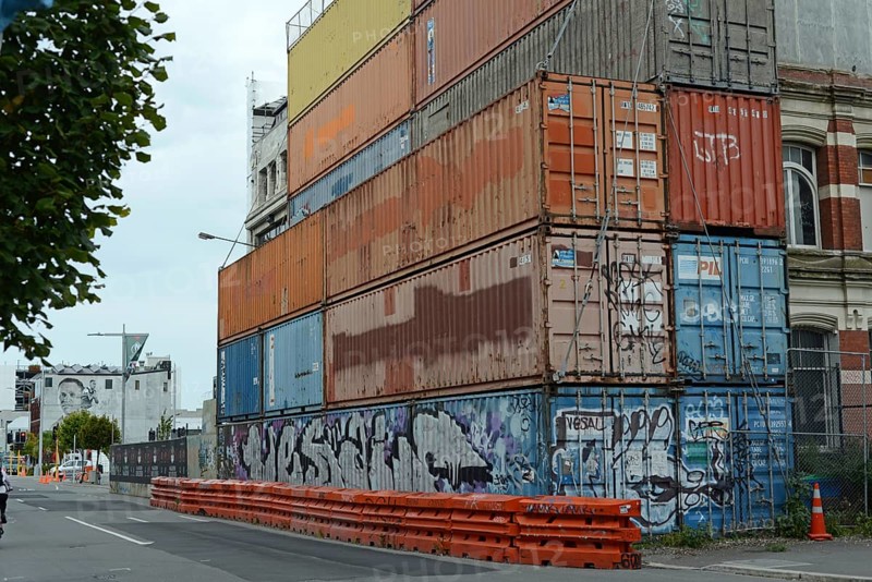 CHRISTCHURCH, NEW ZEALAND, FEBRUARY 24, 2022: Shipping containers continue to stabilise a damaged building, 11 years after the city was devastated by an earthquake