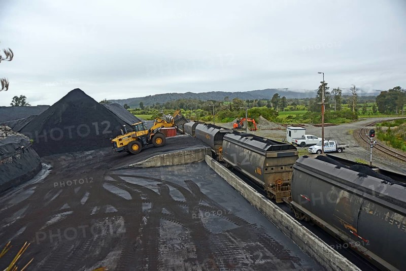 STILLWATER, NEW ZEALAND, OCTOBER 25, 2019: A payloader fills train wagons with coal at the siding at Stillwater, West Coast, New Zealand, Oceania