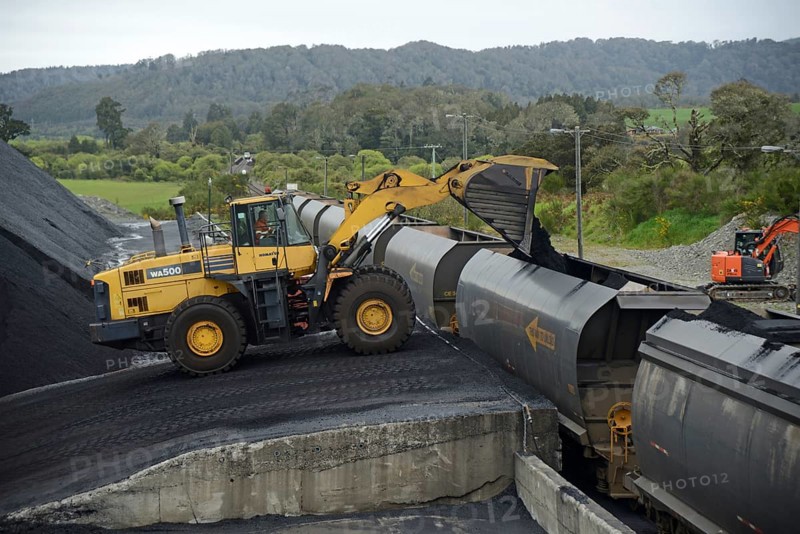 STILLWATER, NEW ZEALAND, OCTOBER 25, 2019: A payloader fills train wagons with coal at the siding at Stillwater, West Coast, New Zealand, Oceania