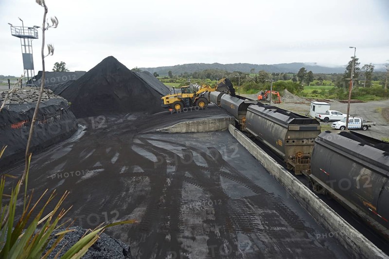 STILLWATER, NEW ZEALAND, OCTOBER 25, 2019: A payloader fills train wagons with coal at the siding at Stillwater, West Coast, New Zealand, Oceania