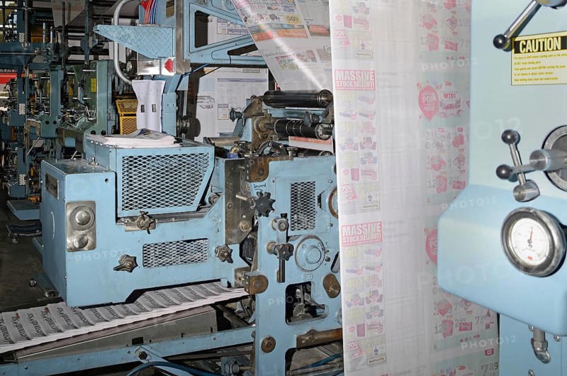 GREYMOUTH, NEW ZEALAND, MAY 22, 2015: Advertisements dominate the pages while printing a newspaper on May 22, 2015 in Greymouth, New Zealand, Oceania