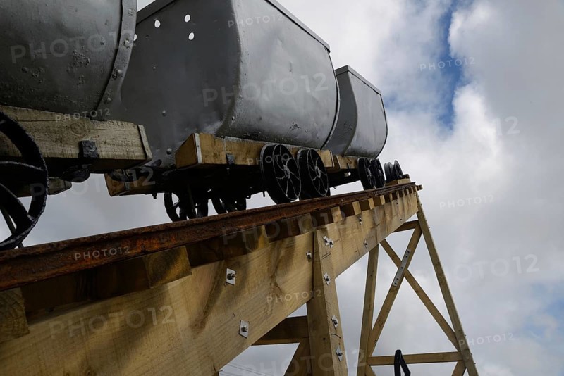 A coal mining memorial at Dobson in New Zealand features vintage coal wagons from an underground mine
