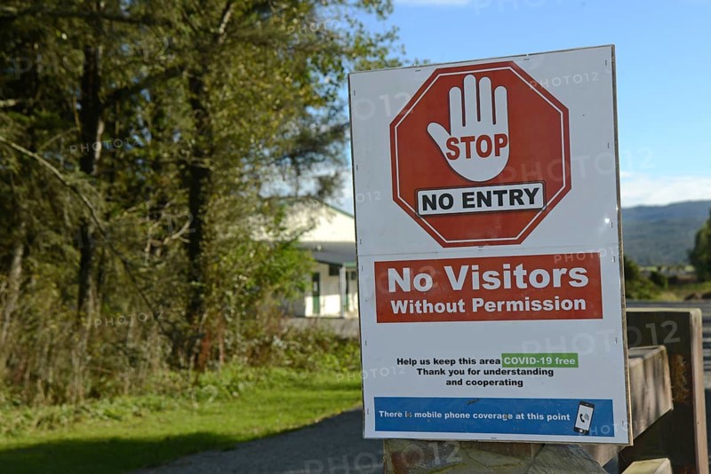 Signage shows that an essential business has restricted access during the Covid 19 lockdown in New Zealand, March 2020
