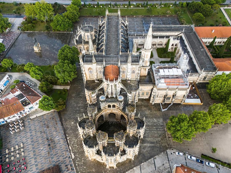 Aerial view of a Gothic abbey with elaborate architecture surrounded by trees and squares, aerial view, monastery, Mosteiro de Santa Maria da Vitoria, 'unfinished chapels', UNESCO World Heritage Site, Batalha, Leiria, Estremadura, Portugal, Europe