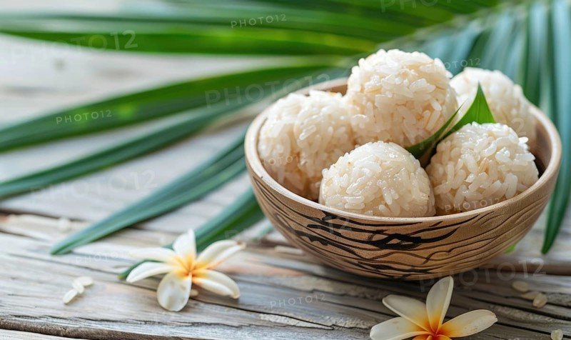 Thai coconut rice dumplings on a light wooden background AI generated