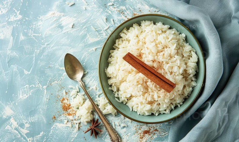 Puerto Rican arroz con dulce with cinnamon on a light blue background AI generated